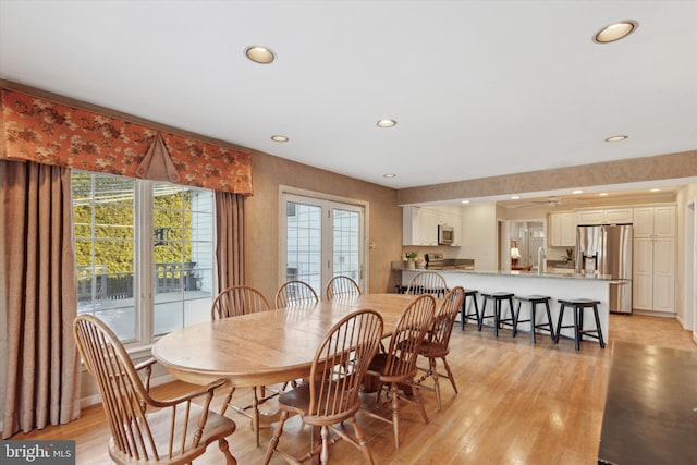 dining room with light hardwood / wood-style floors and sink