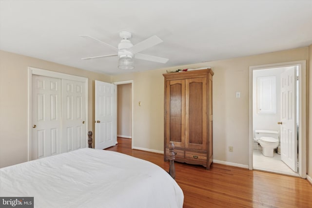 bedroom featuring ceiling fan, ensuite bathroom, hardwood / wood-style floors, and a closet