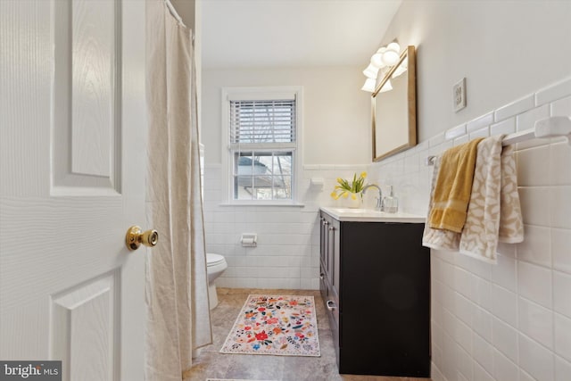 bathroom featuring tile walls, toilet, tile patterned floors, and vanity