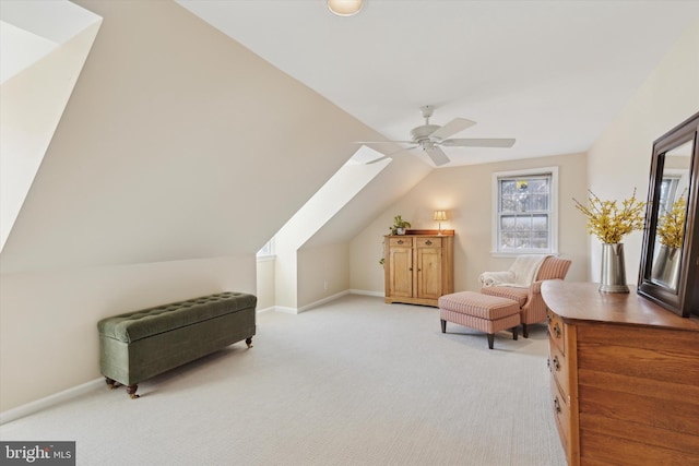 living area with ceiling fan, light colored carpet, and lofted ceiling