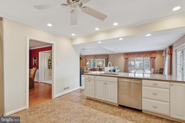 kitchen with sink, dishwasher, crown molding, and light stone countertops