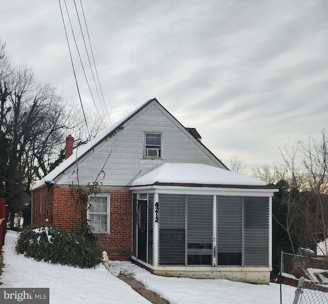 view of front of house with a sunroom