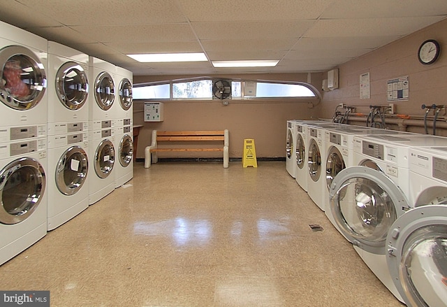 washroom with washing machine and dryer and stacked washer / drying machine