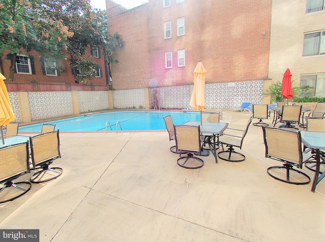 view of swimming pool with a patio area