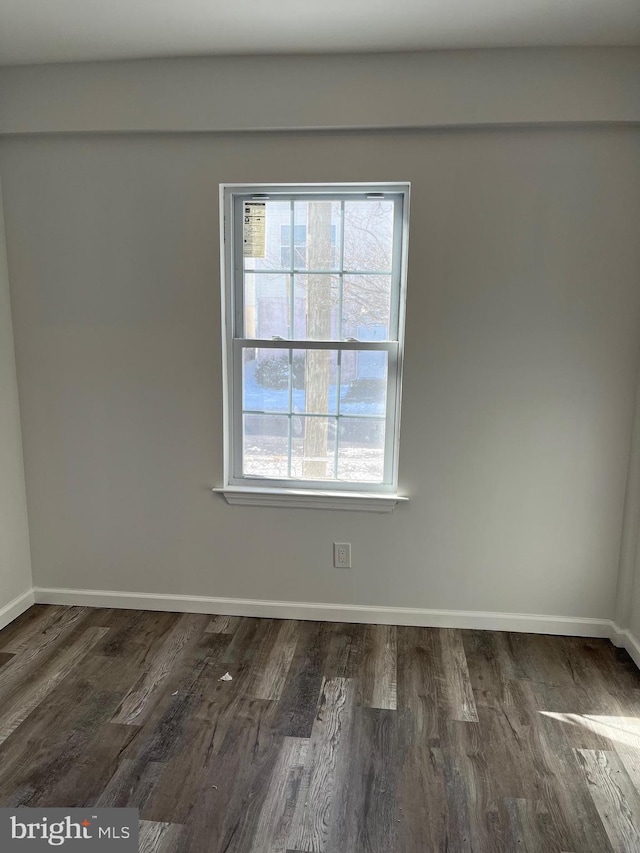 unfurnished room with a wealth of natural light and dark hardwood / wood-style floors