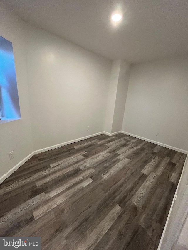 empty room featuring dark wood-type flooring