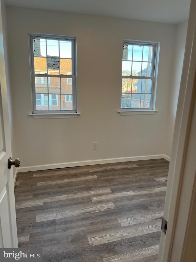 spare room featuring dark hardwood / wood-style floors