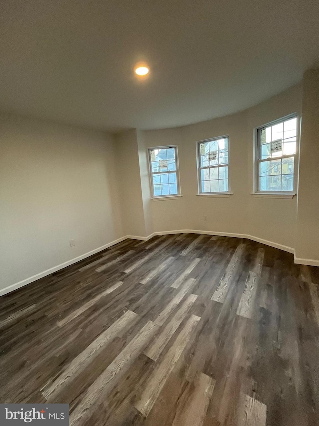 spare room featuring dark hardwood / wood-style floors