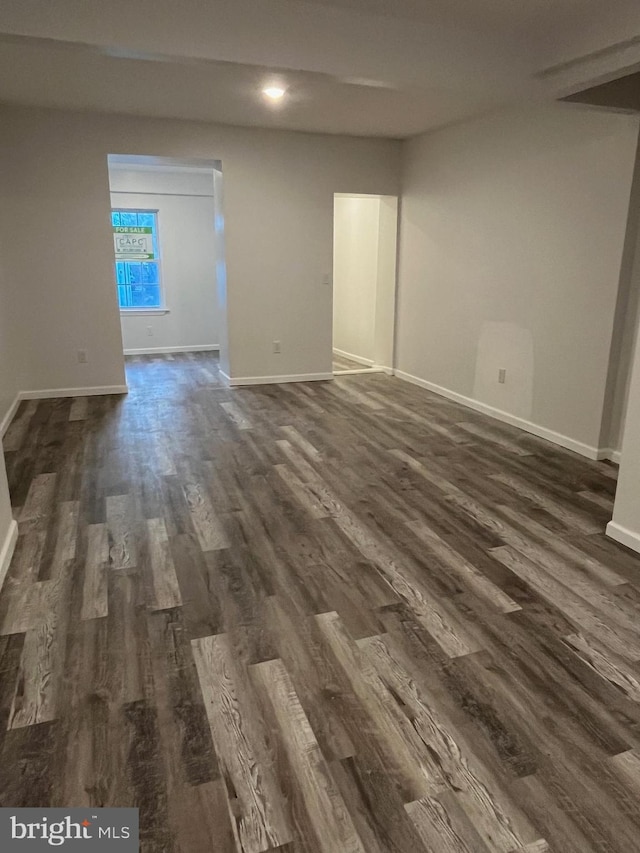 unfurnished room with dark hardwood / wood-style flooring