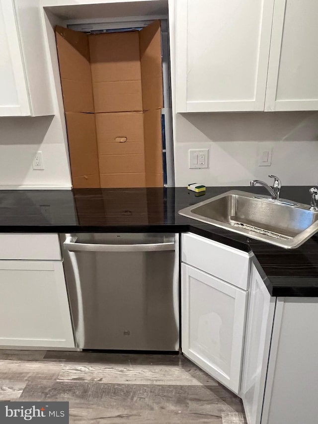 kitchen with white cabinetry, stainless steel dishwasher, and sink