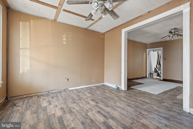 spare room with ceiling fan and hardwood / wood-style flooring