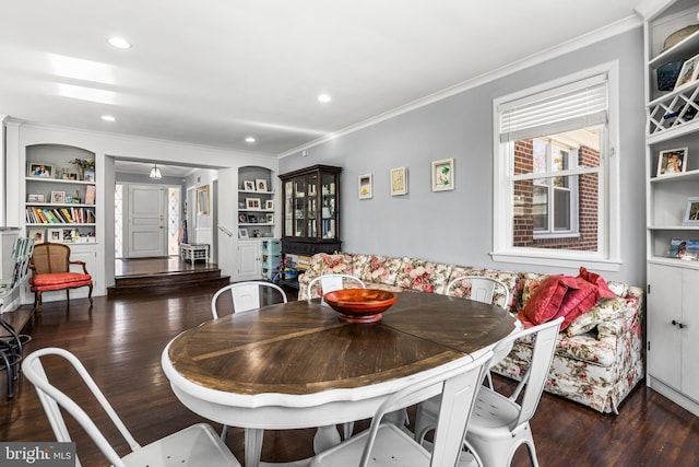 dining area featuring breakfast area, crown molding, built in features, and dark wood-type flooring