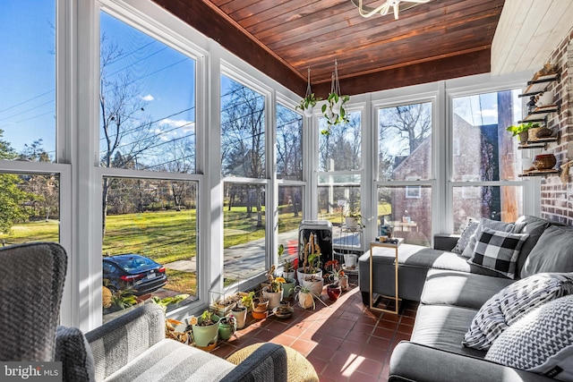 sunroom / solarium with a healthy amount of sunlight and wooden ceiling