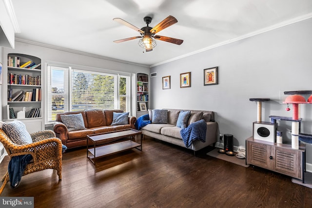 living room featuring crown molding, built in features, ceiling fan, and dark wood-type flooring