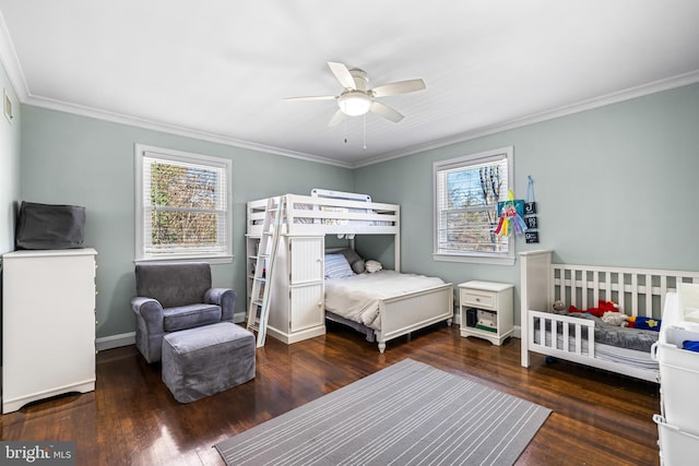 bedroom featuring dark hardwood / wood-style floors, ceiling fan, and crown molding