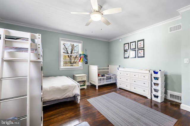 bedroom featuring dark hardwood / wood-style flooring, ceiling fan, and ornamental molding