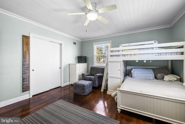 bedroom with ceiling fan, crown molding, and dark wood-type flooring