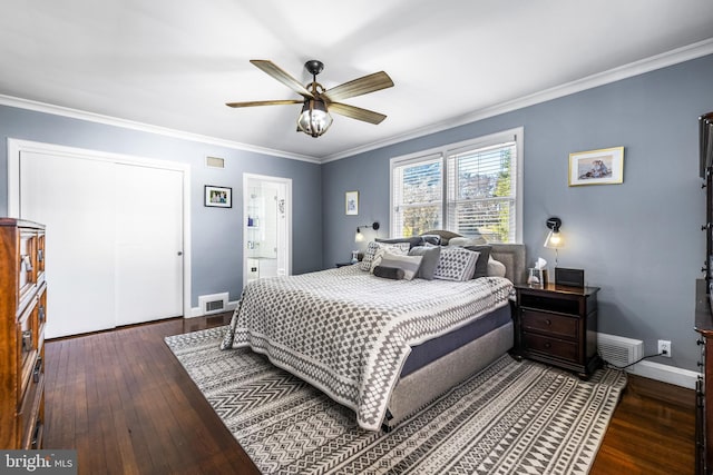 bedroom featuring connected bathroom, ceiling fan, dark wood-type flooring, and ornamental molding