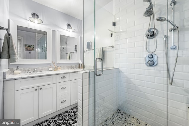 bathroom featuring vanity and an enclosed shower