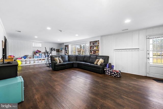 living room with hardwood / wood-style floors and built in shelves