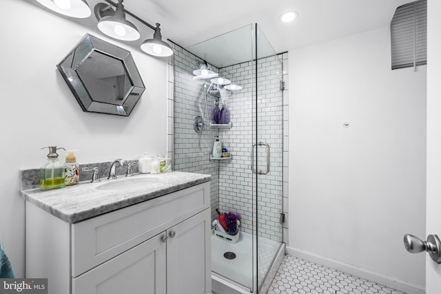 bathroom featuring tile patterned floors, vanity, and a shower with shower door