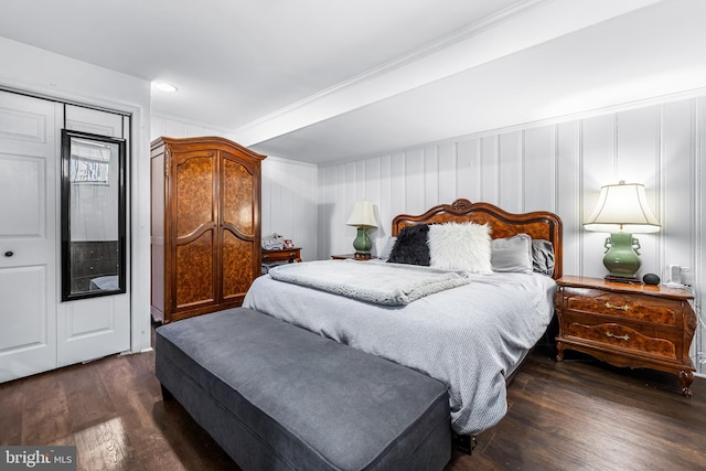 bedroom with dark hardwood / wood-style flooring, a closet, and ornamental molding