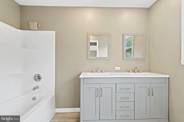 bathroom with washtub / shower combination and vanity