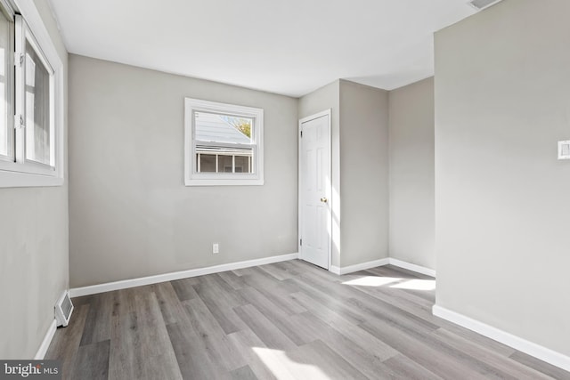 unfurnished room with light hardwood / wood-style floors