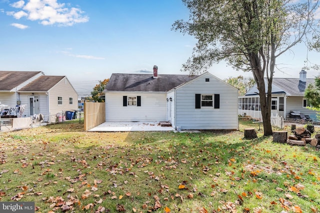 back of house with a patio area and a yard