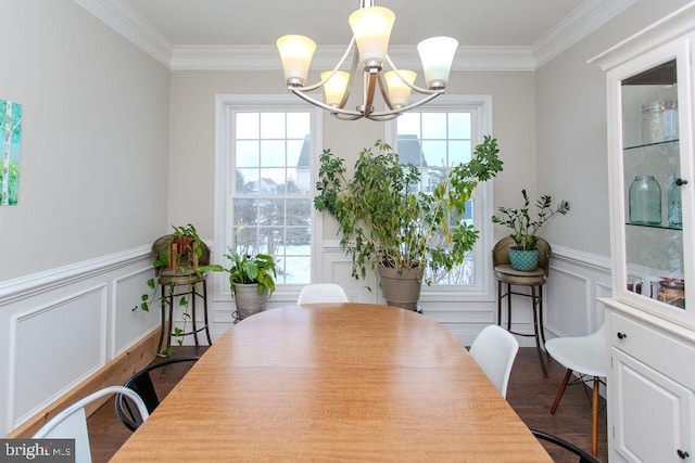 dining space with plenty of natural light, ornamental molding, and a chandelier