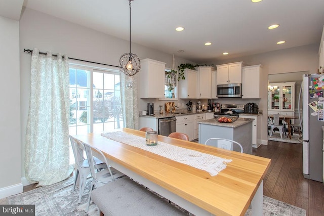 dining area featuring dark wood-type flooring and sink