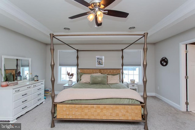 bedroom featuring light carpet, multiple windows, ceiling fan, and ornamental molding