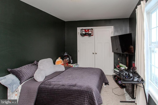 carpeted bedroom featuring a closet