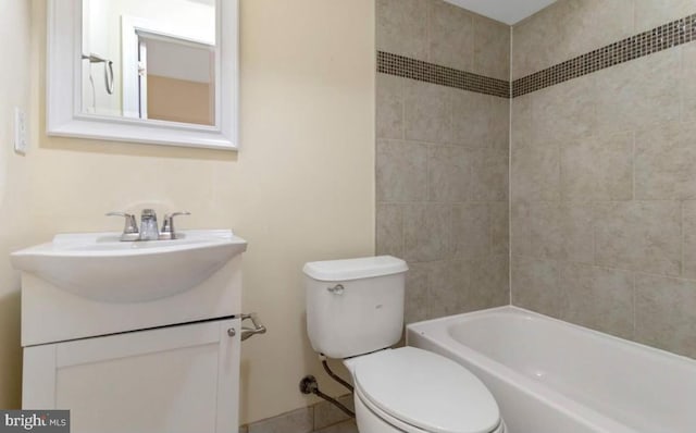 full bathroom with vanity, toilet, and tiled shower / bath combo