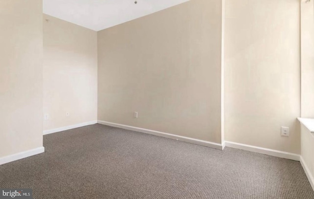 empty room with dark colored carpet