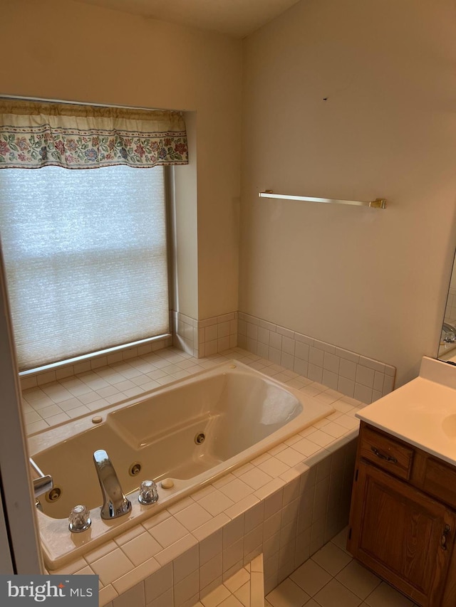 bathroom with vanity, tile patterned floors, and tiled tub