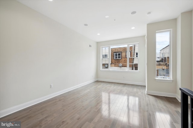 unfurnished living room featuring plenty of natural light and light hardwood / wood-style flooring