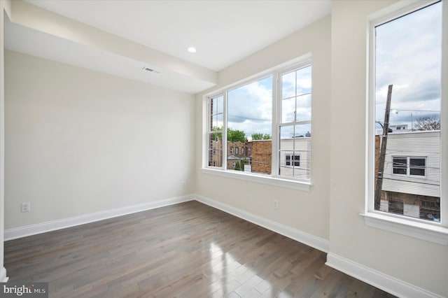 empty room featuring dark hardwood / wood-style flooring