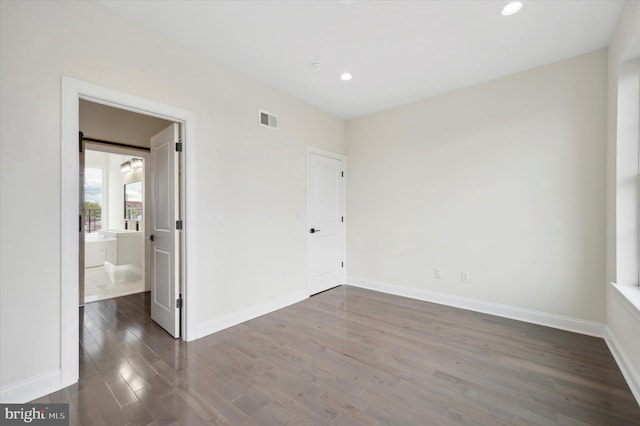 unfurnished room with dark hardwood / wood-style flooring