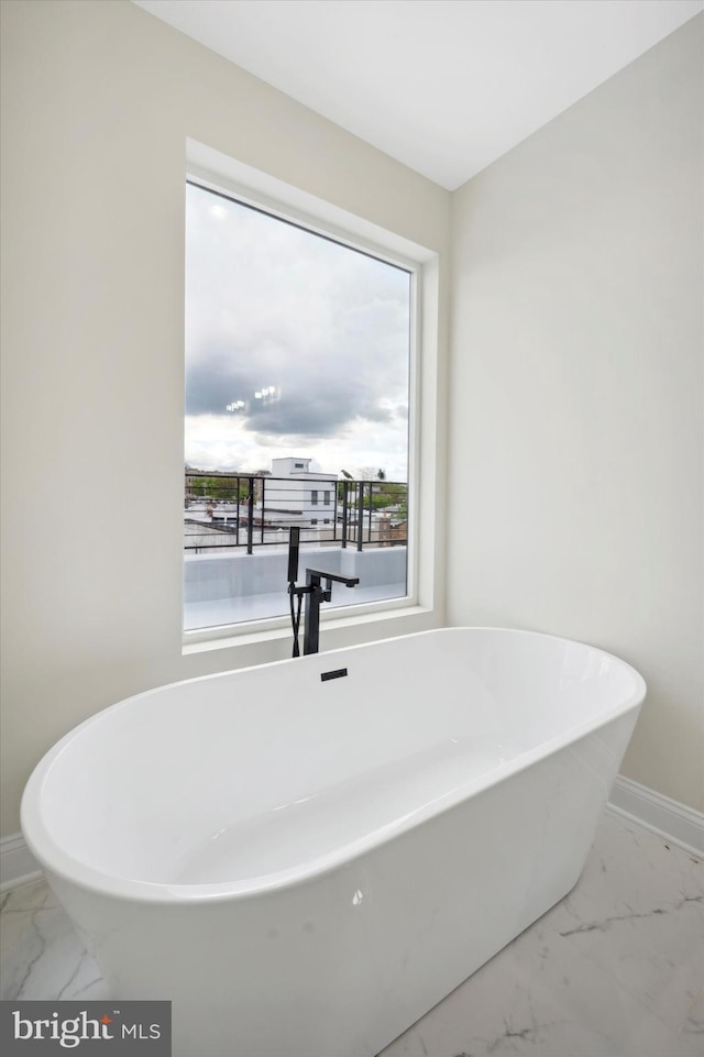 bathroom with a tub to relax in