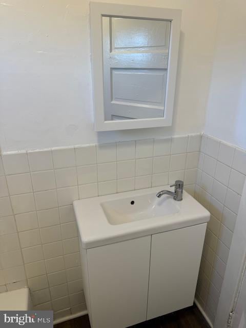 bathroom with tile walls and sink