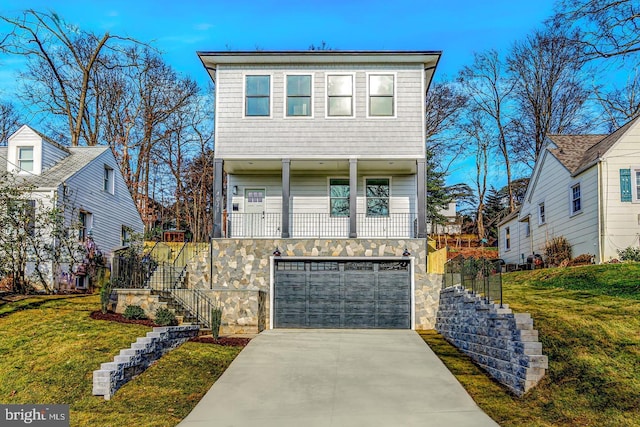 view of front of property featuring a garage and a front yard