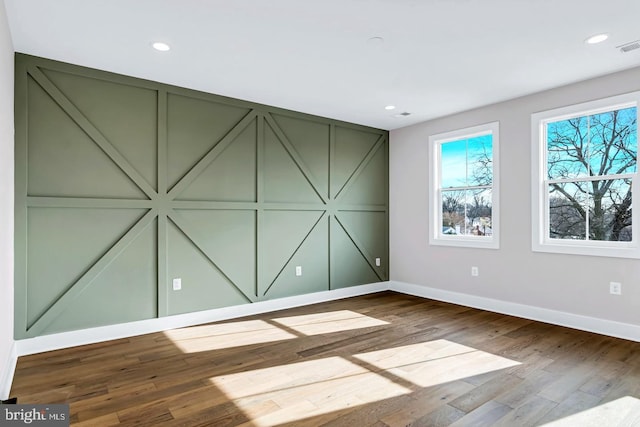 unfurnished room with wood-type flooring