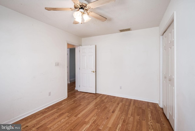 unfurnished bedroom featuring hardwood / wood-style flooring and ceiling fan