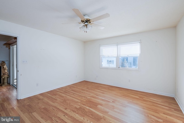 empty room with ceiling fan and light wood-type flooring