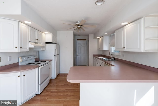 kitchen featuring white electric range, kitchen peninsula, light hardwood / wood-style flooring, ceiling fan, and white cabinetry