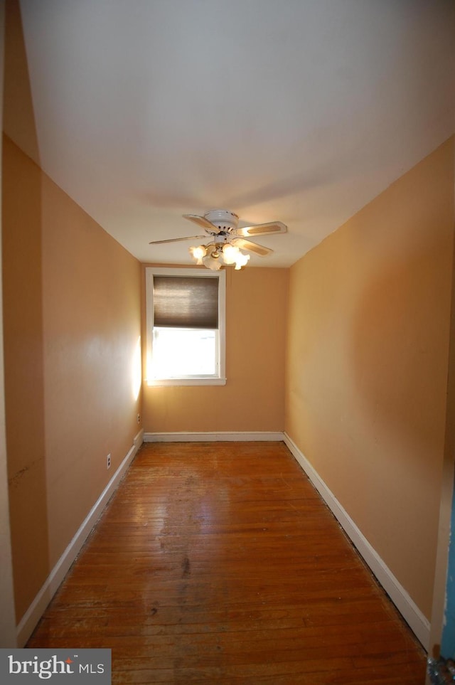 empty room featuring hardwood / wood-style flooring and ceiling fan