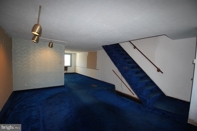 basement featuring dark carpet