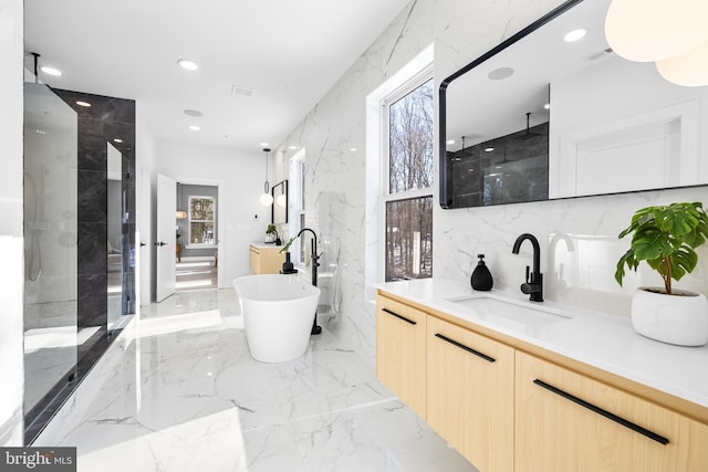 bathroom featuring vanity, plus walk in shower, and tile walls