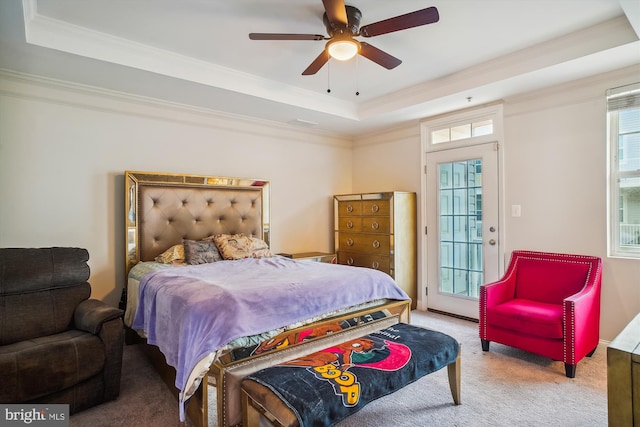 bedroom featuring access to outside, a raised ceiling, crown molding, ceiling fan, and light colored carpet